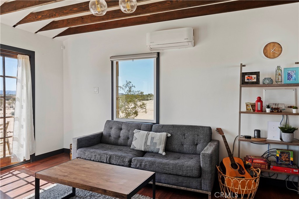 66750 Pole Line Road Joshua Tree, CA 92252 - Photo 11 of 36 a living room with furniture and a window