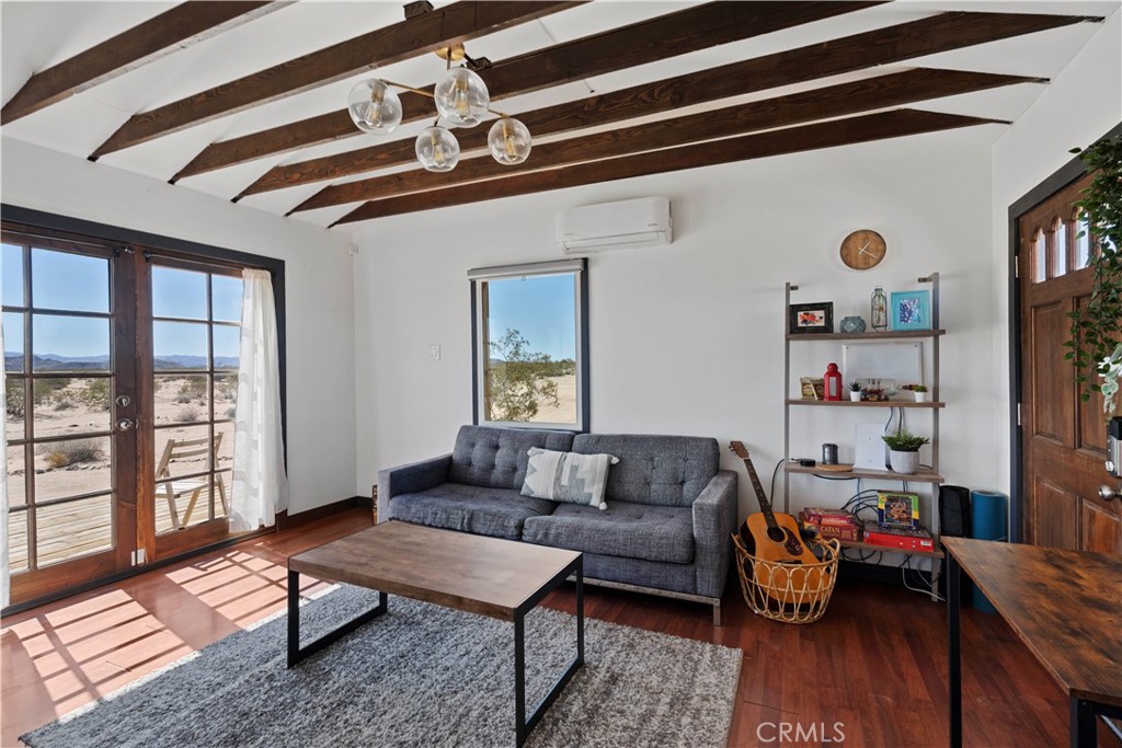 66750 Pole Line Road Joshua Tree, CA 92252 - Photo 12 of 36 a living room with furniture and a window