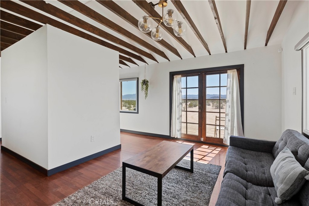 66750 Pole Line Road Joshua Tree, CA 92252 - Photo 13 of 36 a living room with furniture and a window