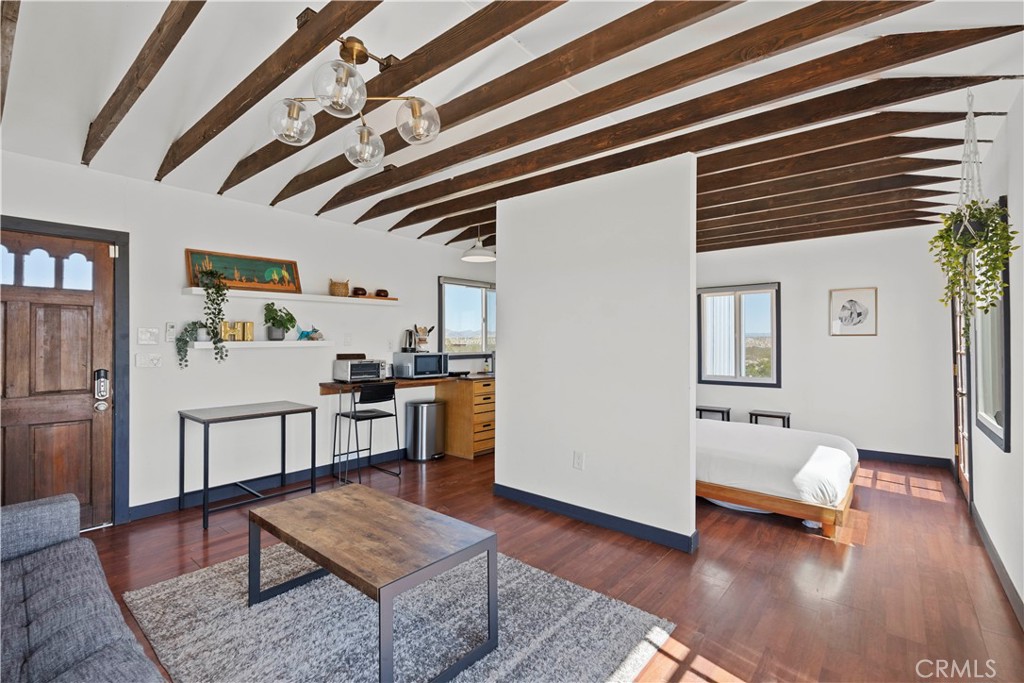 66750 Pole Line Road Joshua Tree, CA 92252 - Photo 14 of 36 a living room with furniture and wooden floor