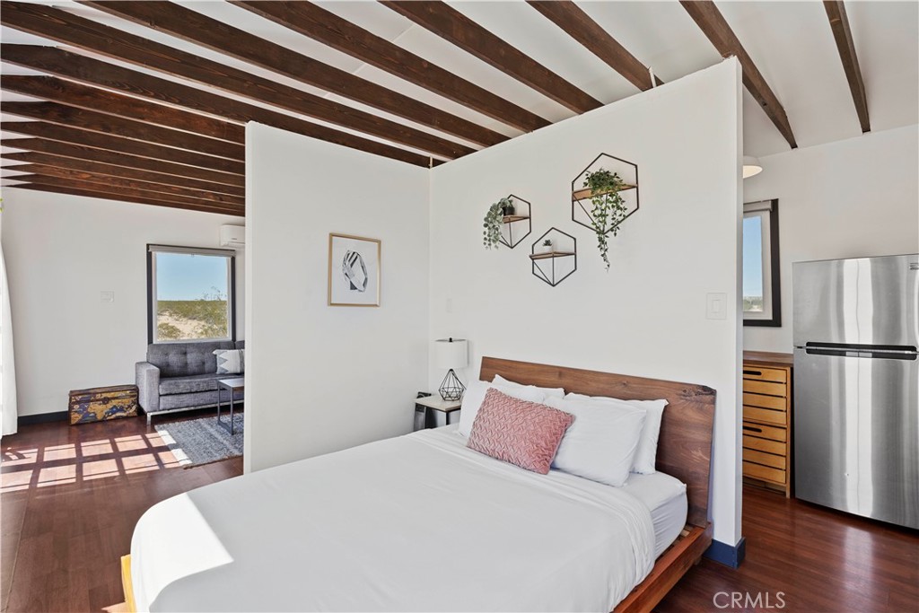 66750 Pole Line Road Joshua Tree, CA 92252 - Photo 16 of 36 a bedroom with a bed and a table