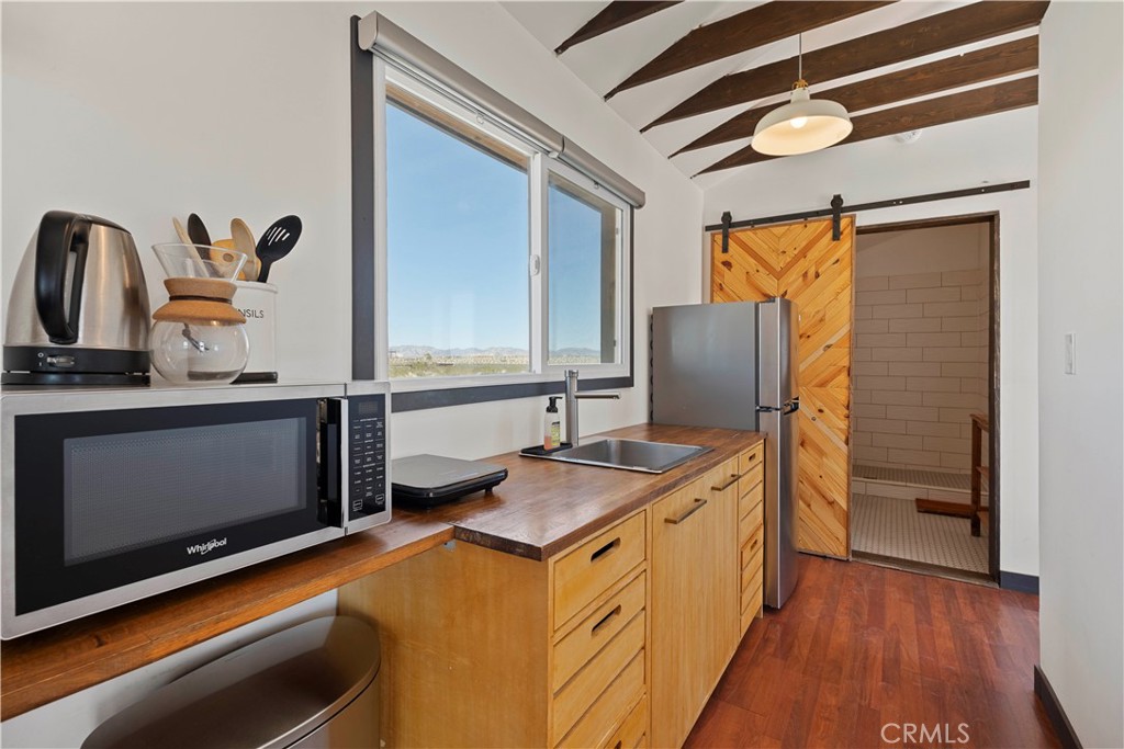 66750 Pole Line Road Joshua Tree, CA 92252 - Photo 19 of 36 a bathroom with a granite countertop sink and a mirror