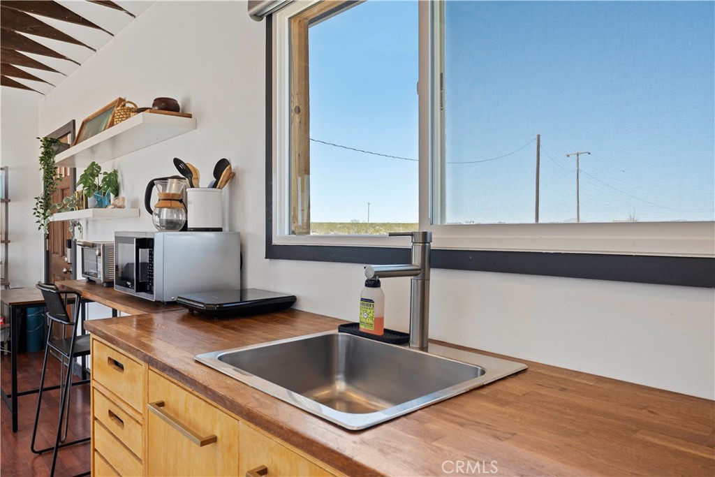 66750 Pole Line Road Joshua Tree, CA 92252 - Photo 23 of 36 a kitchen with a sink and a stove top oven