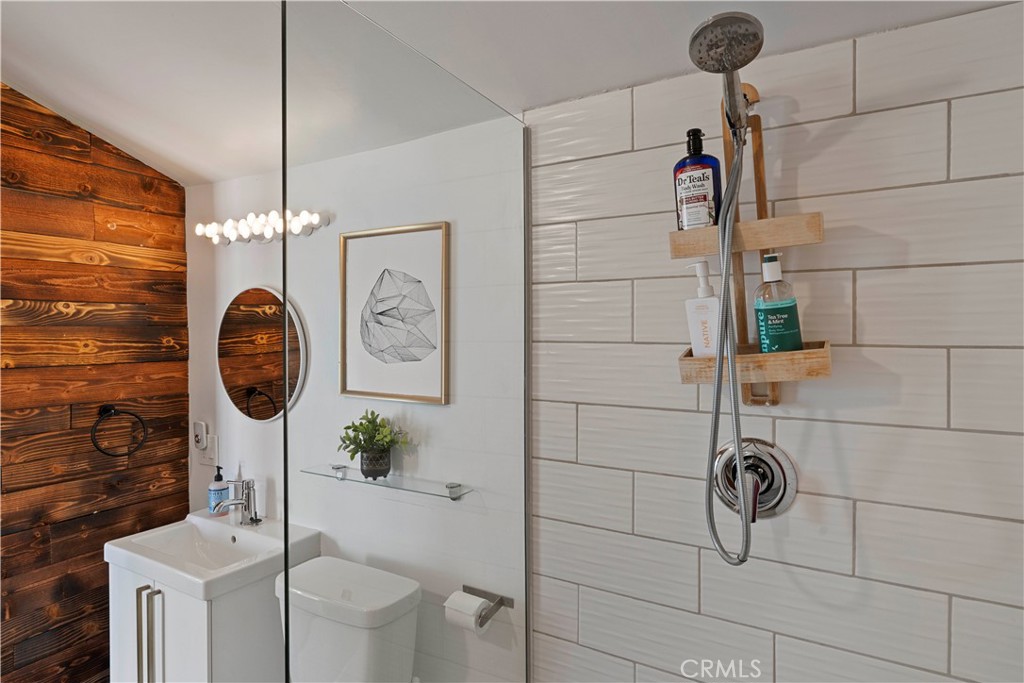 66750 Pole Line Road Joshua Tree, CA 92252 - Photo 28 of 36 a bathroom with a toilet a sink and mirror
