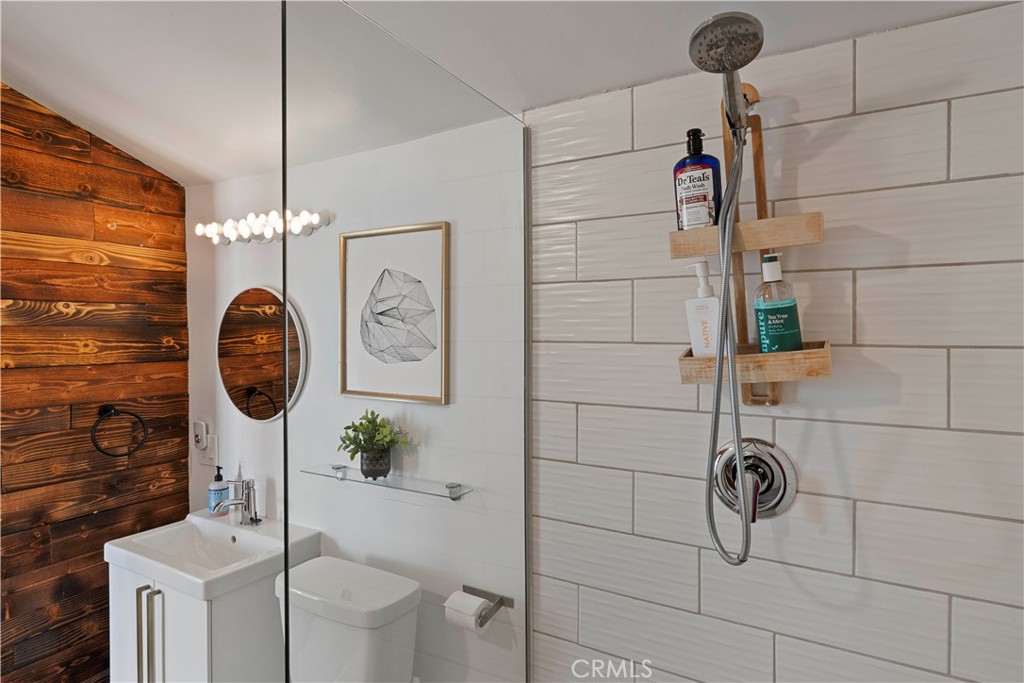 66750 Pole Line Road Joshua Tree, CA 92252 - Photo 28 of 36 a bathroom with a toilet a sink and mirror