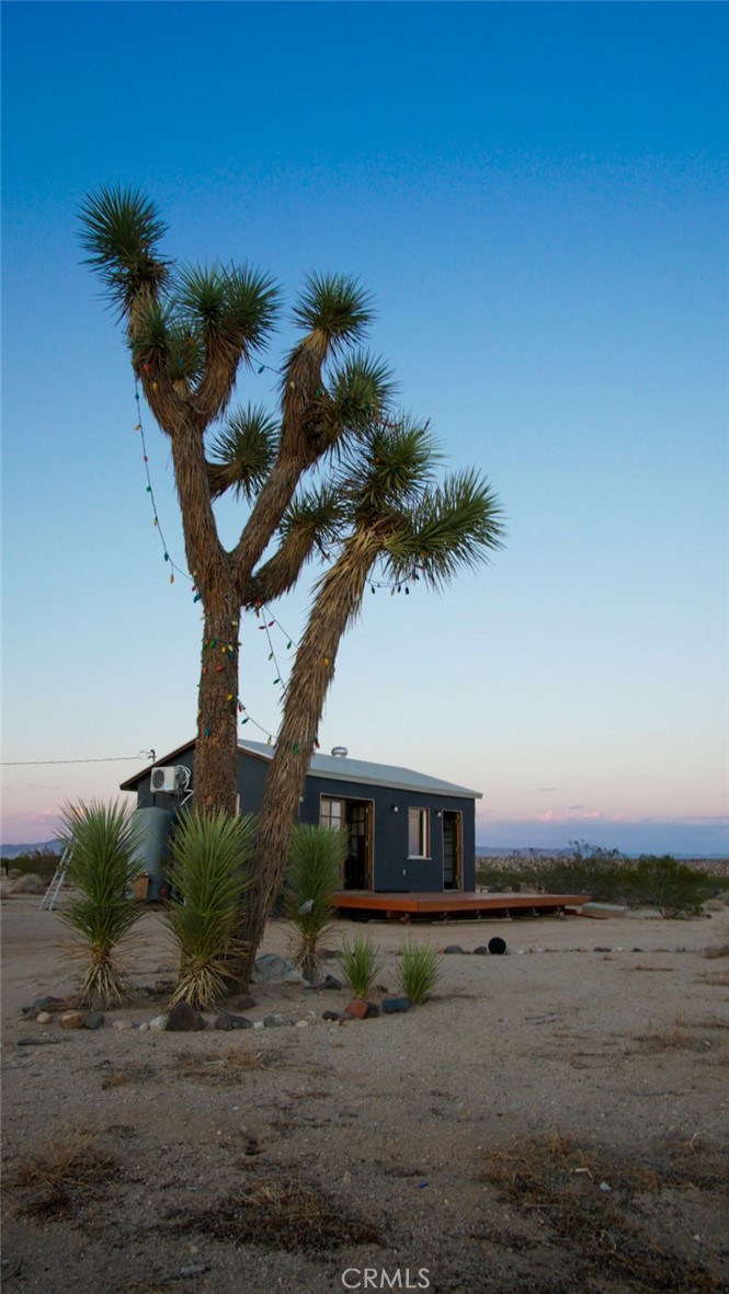 66750 Pole Line Road Joshua Tree, CA 92252 - Photo 35 of 36 a view of a house with a yard