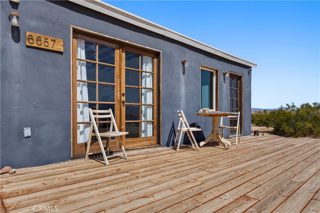 66750 Pole Line Road Joshua Tree, CA 92252 - Photo 7 of 36 a view of a chairs and table on the wooden floor