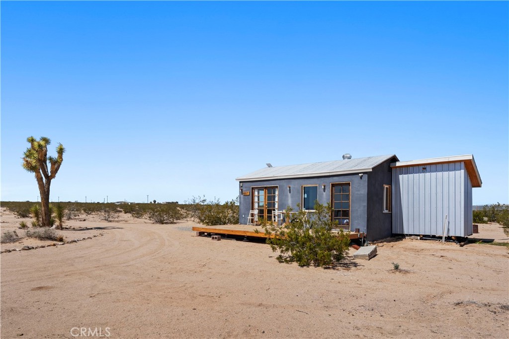 66750 Pole Line Road Joshua Tree, CA 92252 - Photo 8 of 36 a view of a house with a yard