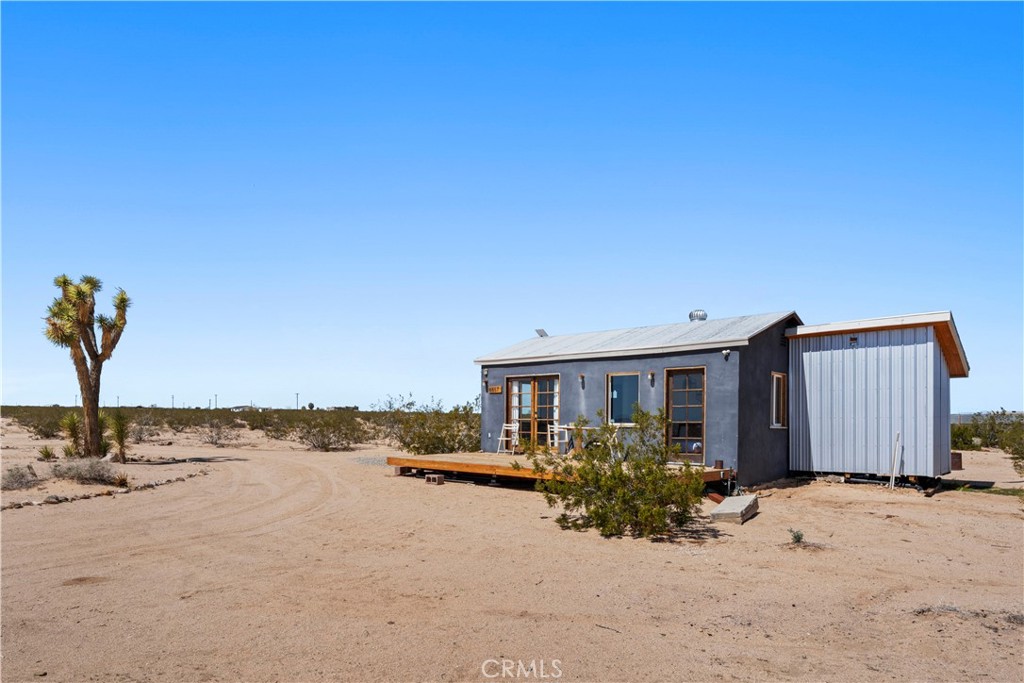 66750 Pole Line Road Joshua Tree, CA 92252 - Photo 8 of 36 a view of a house with a yard
