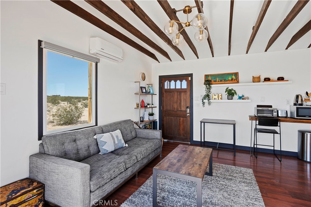 66750 Pole Line Road Joshua Tree, CA 92252 - Photo 9 of 36 a living room with furniture and a rug