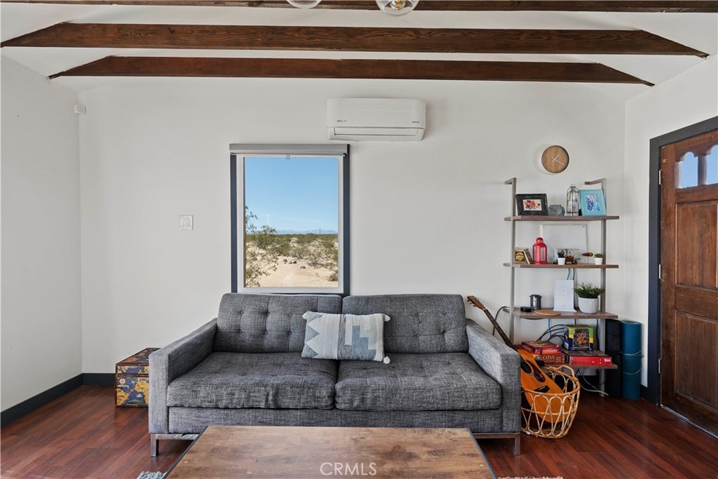 66750 Pole Line Road Joshua Tree, CA 92252 - Photo 10 of 36 a living room with furniture and a wooden floor