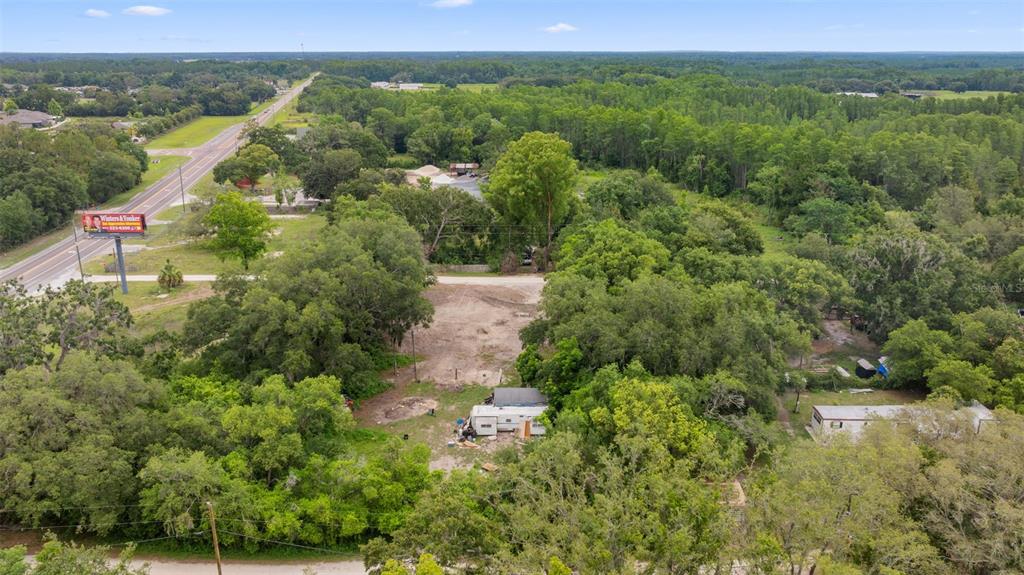 19057 Malabar Avenue Spring Hill, FL 34610 - Photo 15 of 23 an aerial view of green landscape with trees houses and mountain view