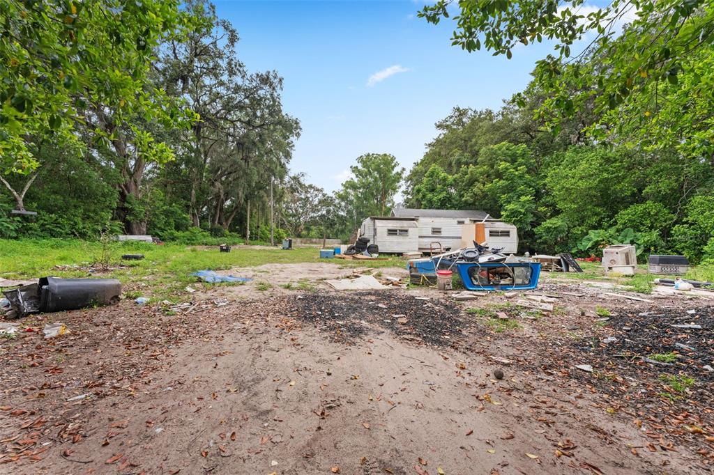 19057 Malabar Avenue Spring Hill, FL 34610 - Photo 4 of 23 a view of a yard with a tree