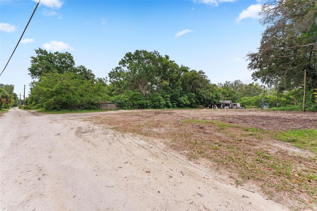 19057 Malabar Avenue Spring Hill, FL 34610 - Photo 7 of 23 a view of a field with trees in the background