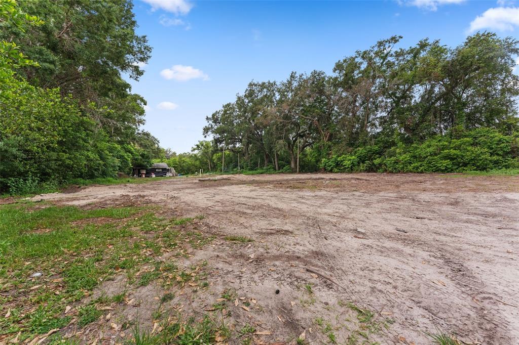 19057 Malabar Avenue Spring Hill, FL 34610 - Photo 8 of 23 a view of a field with trees in the background