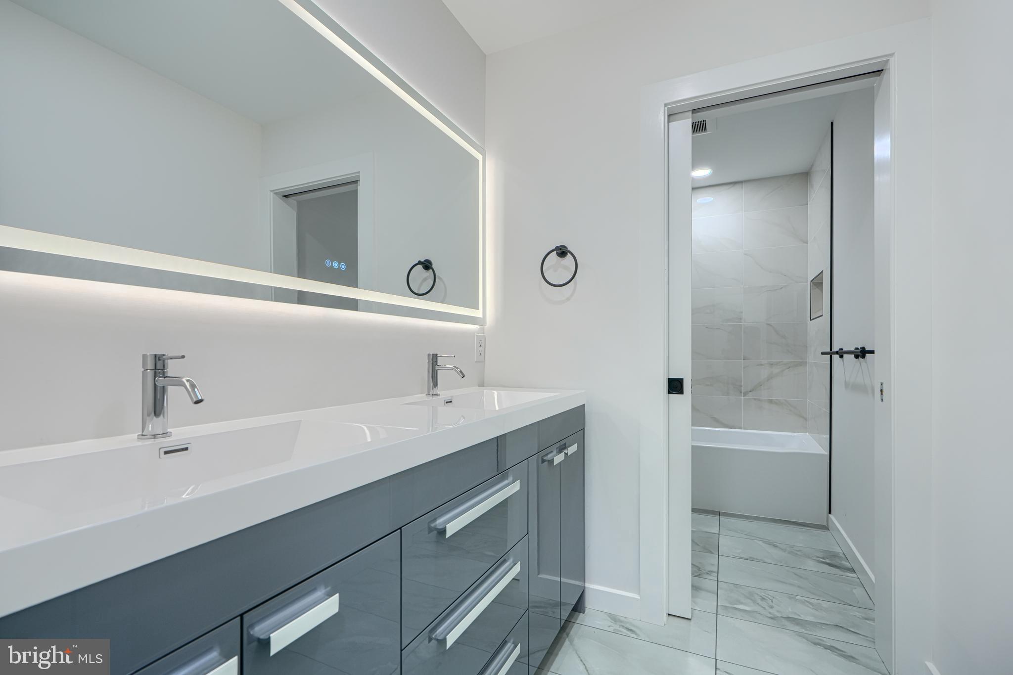 3410 Pinkney Road Baltimore, MD 21215 - Photo 31 of 55 a bathroom with a tub sink double and mirror