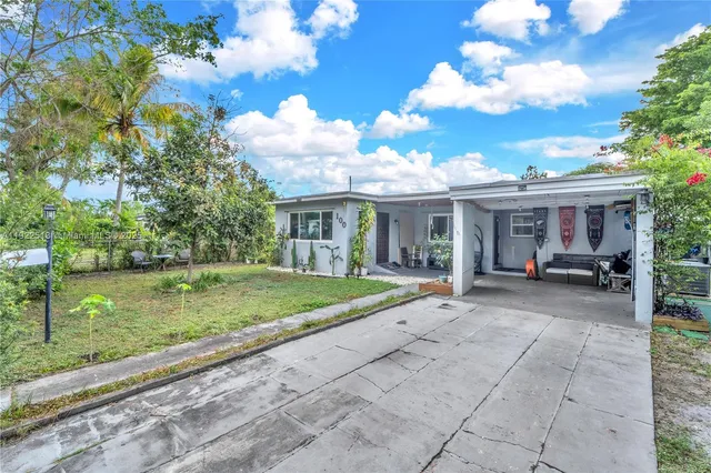 a view of a house with backyard porch and sitting area