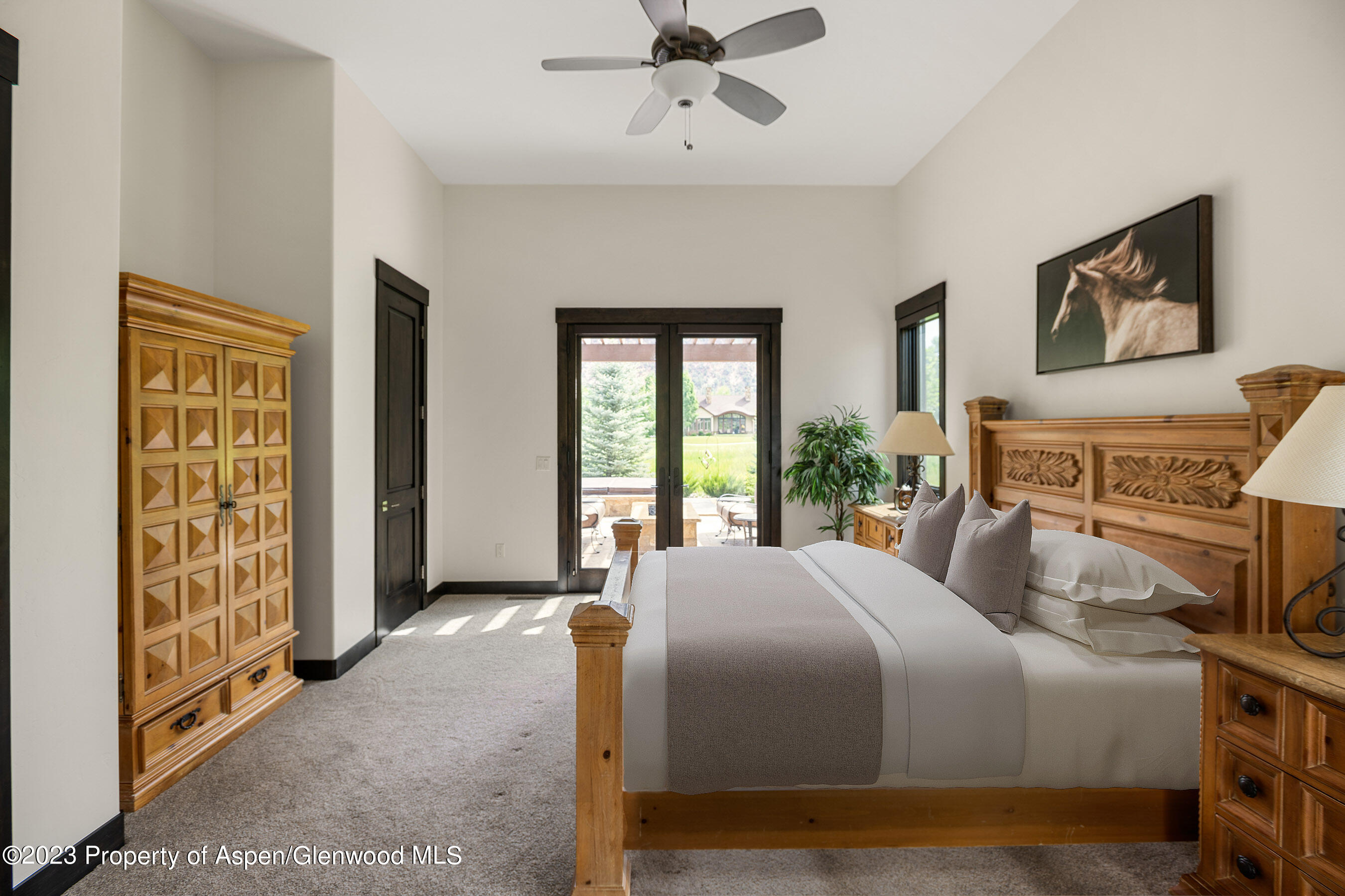 54 Kingfisher Carbondale, CO 81623 - Photo 29 of 39 a bedroom with a large bed and a chandelier