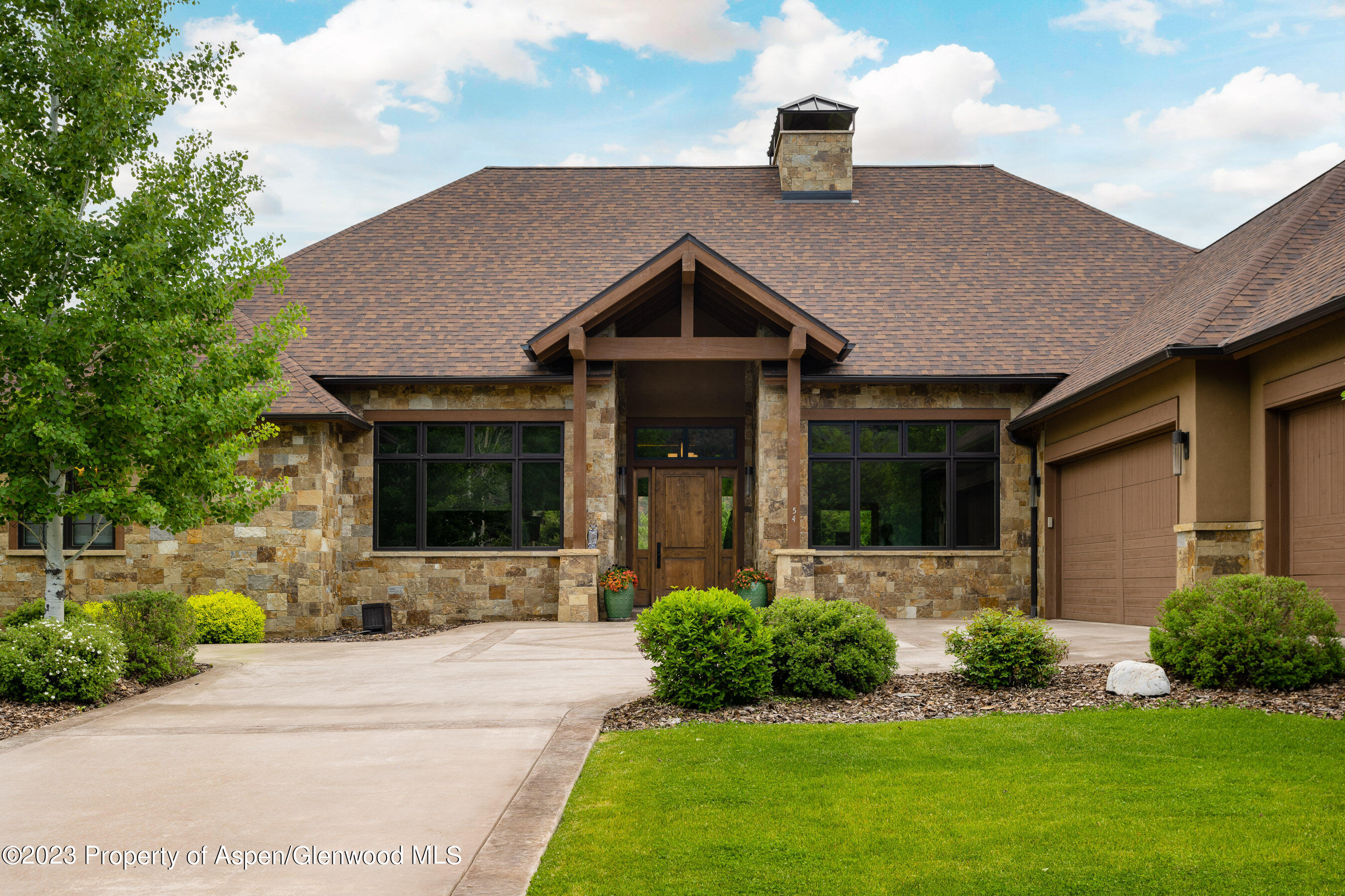 54 Kingfisher Carbondale, CO 81623 - Photo 6 of 39 a front view of a house with a yard and potted plants