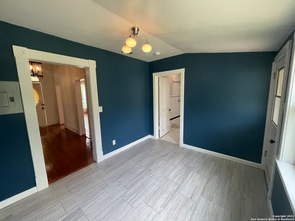 a view of a hallway with wooden floor and closet