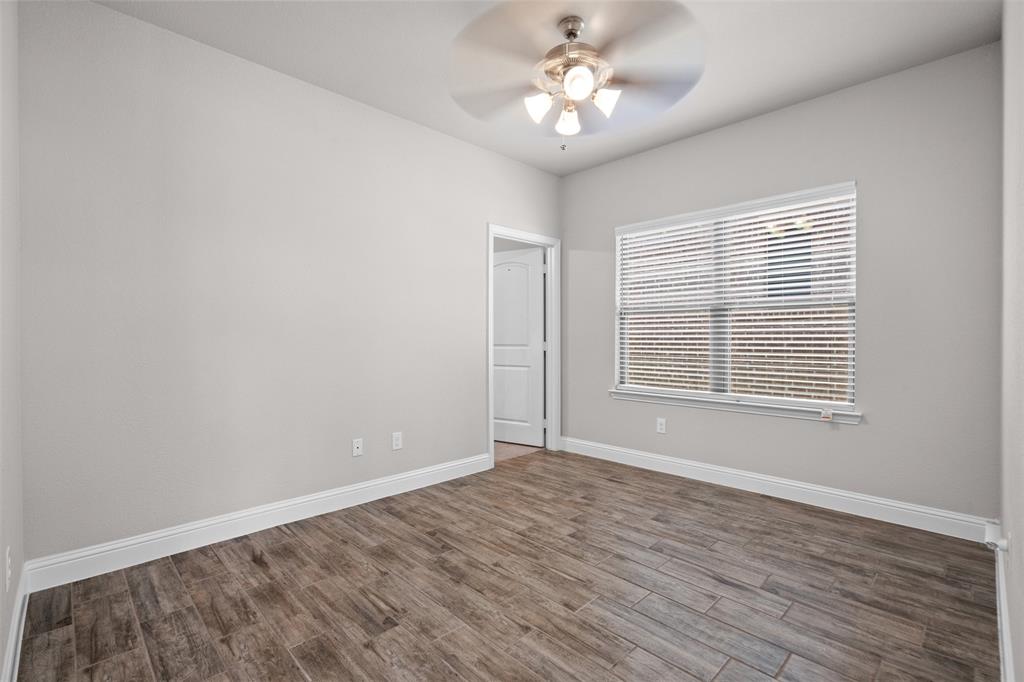 119 Happy Lane Red Oak, TX 75154 - Photo 18 of 37 Room featuring wood-finish flooring, light gray walls, white baseboards, and a window with horizontal blinds