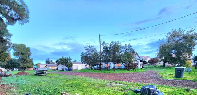 a view of a yard with a house in the background