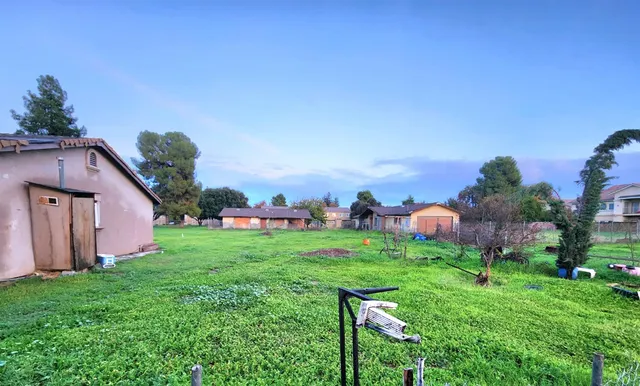 a backyard of a house with lots of green space and plants