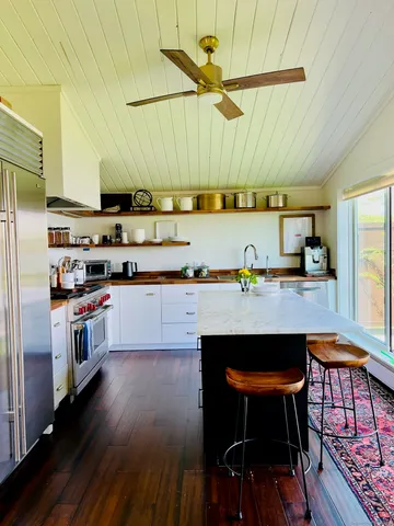a kitchen with stainless steel appliances wooden cabinets and a counter top space