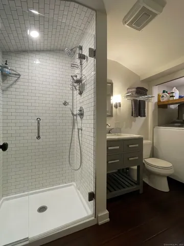 a bathroom with a sink a toilet and shower