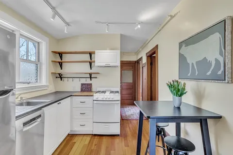 a kitchen with a table and chairs