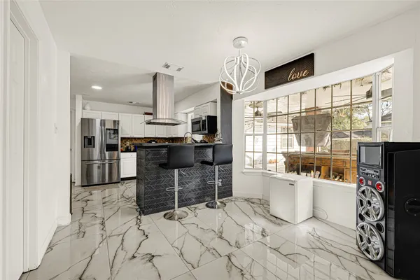 a kitchen with stainless steel appliances kitchen island granite countertop a sink and cabinets