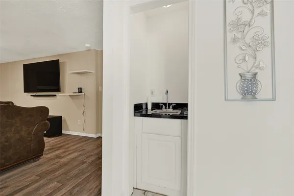 a view of a livingroom with furniture and a flat screen tv