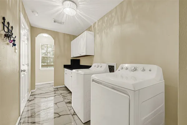 a view of washer and dryer with kitchen view