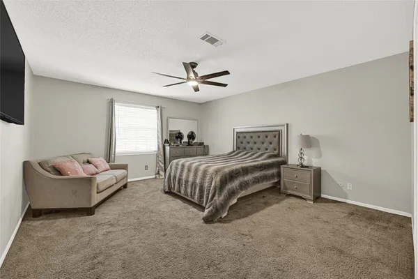 a bedroom with a bed couch and window