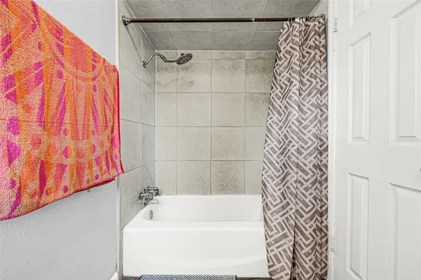 a bathroom with a bathtub and shower