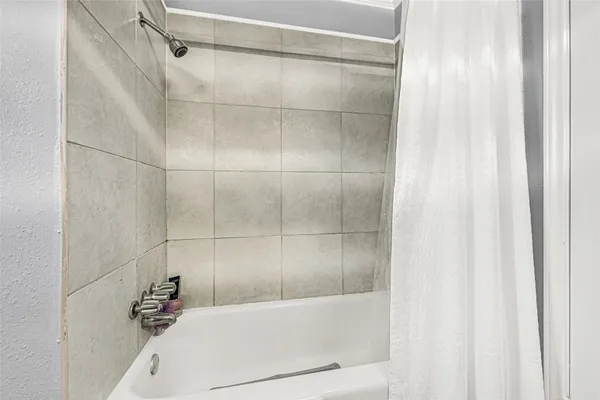 a bathroom with a bathtub and a shower