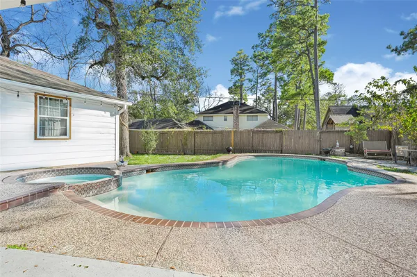 a view of a backyard with a swimming pool