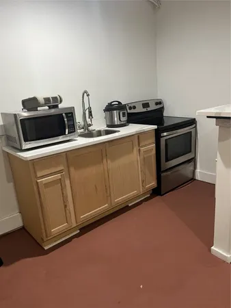 a kitchen with granite countertop a stove and a microwave