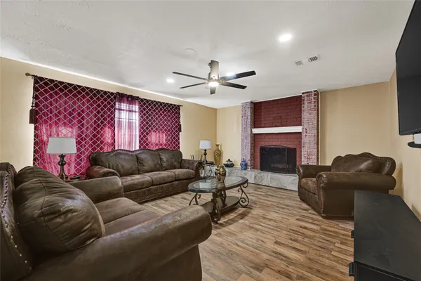 a living room with furniture a fireplace and a flat screen tv