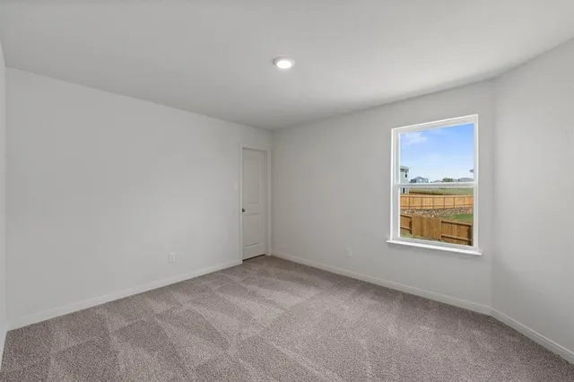 a view of an empty room and a window
