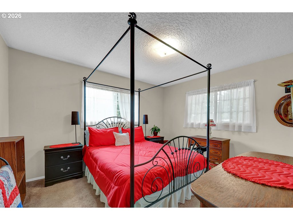 1415 20th Street Florence, OR 97439 - Photo 16 of 40 a bedroom with a bed and a window