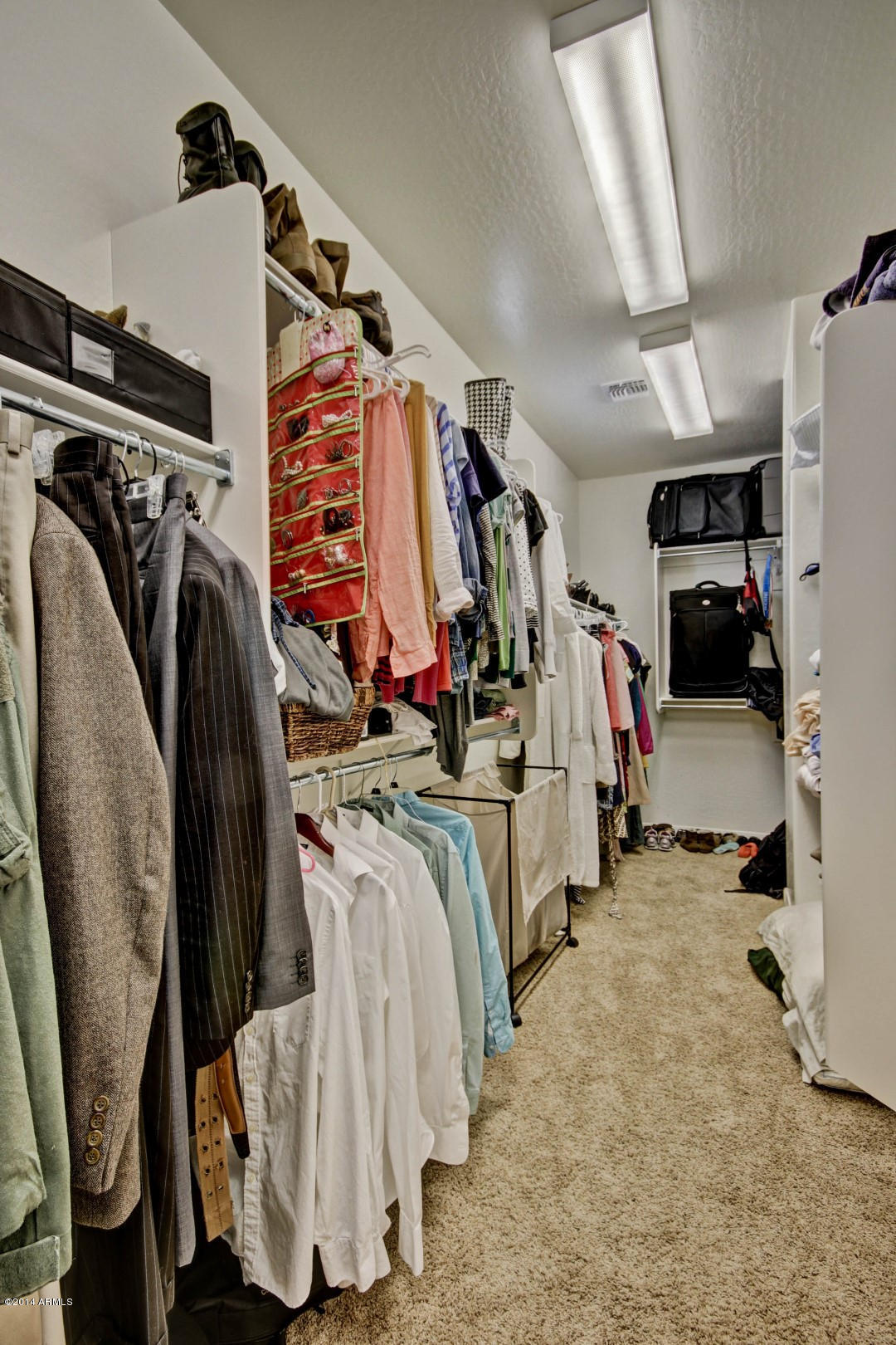 2280 North Alsap Road Buckeye, AZ 85396 - Photo 58 of 65 a view of walk in closet with clothes and shoes