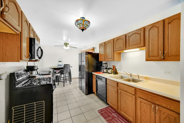 a kitchen with a sink appliances and cabinets