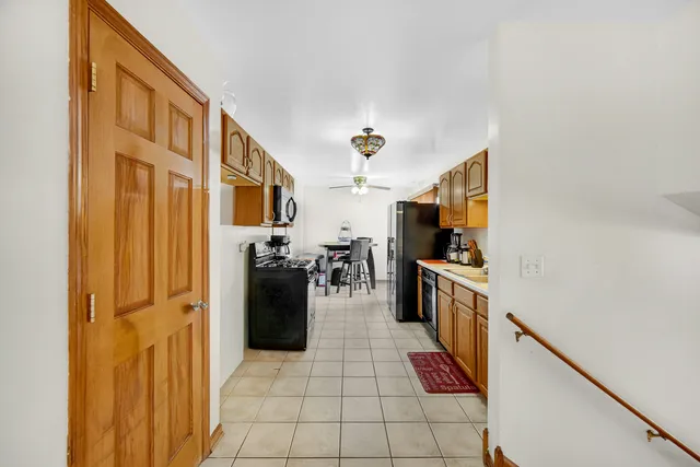a kitchen with stainless steel appliances granite countertop a refrigerator and a stove
