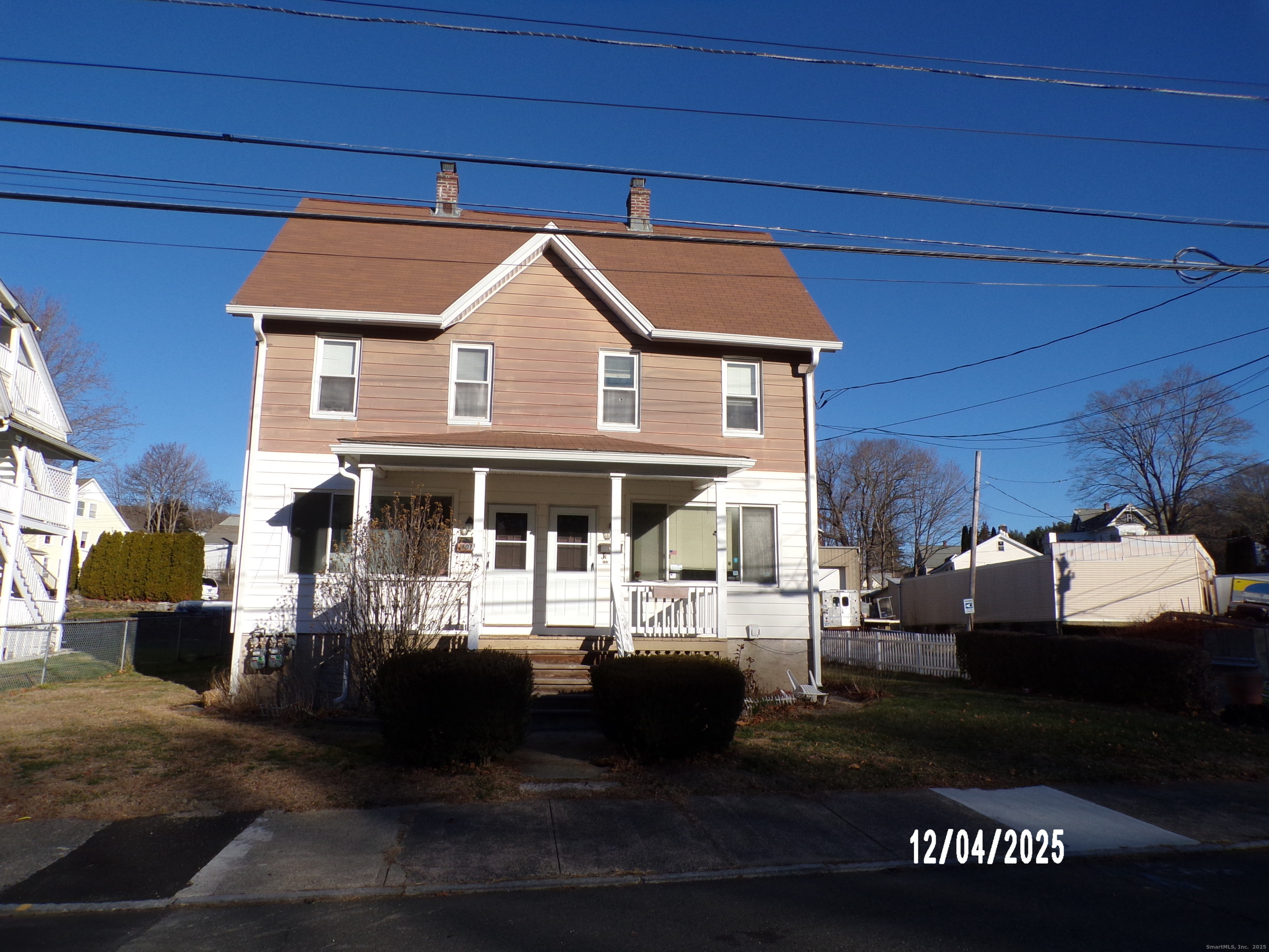 a front view of a house with a ocean