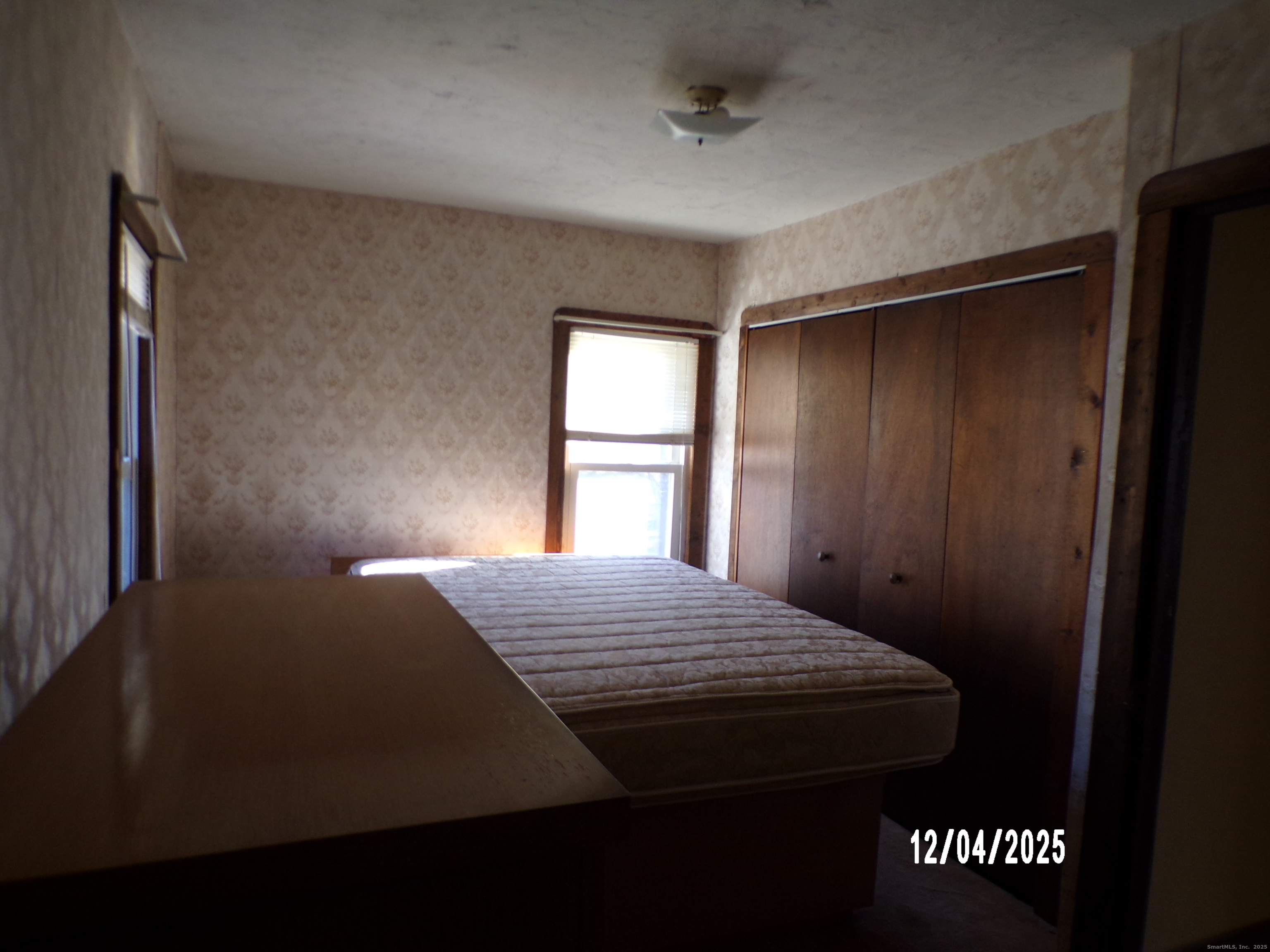103 Myrtle Avenue Ansonia, CT 06401 - Photo 13 of 35 a bed sitting in a bedroom next to a window