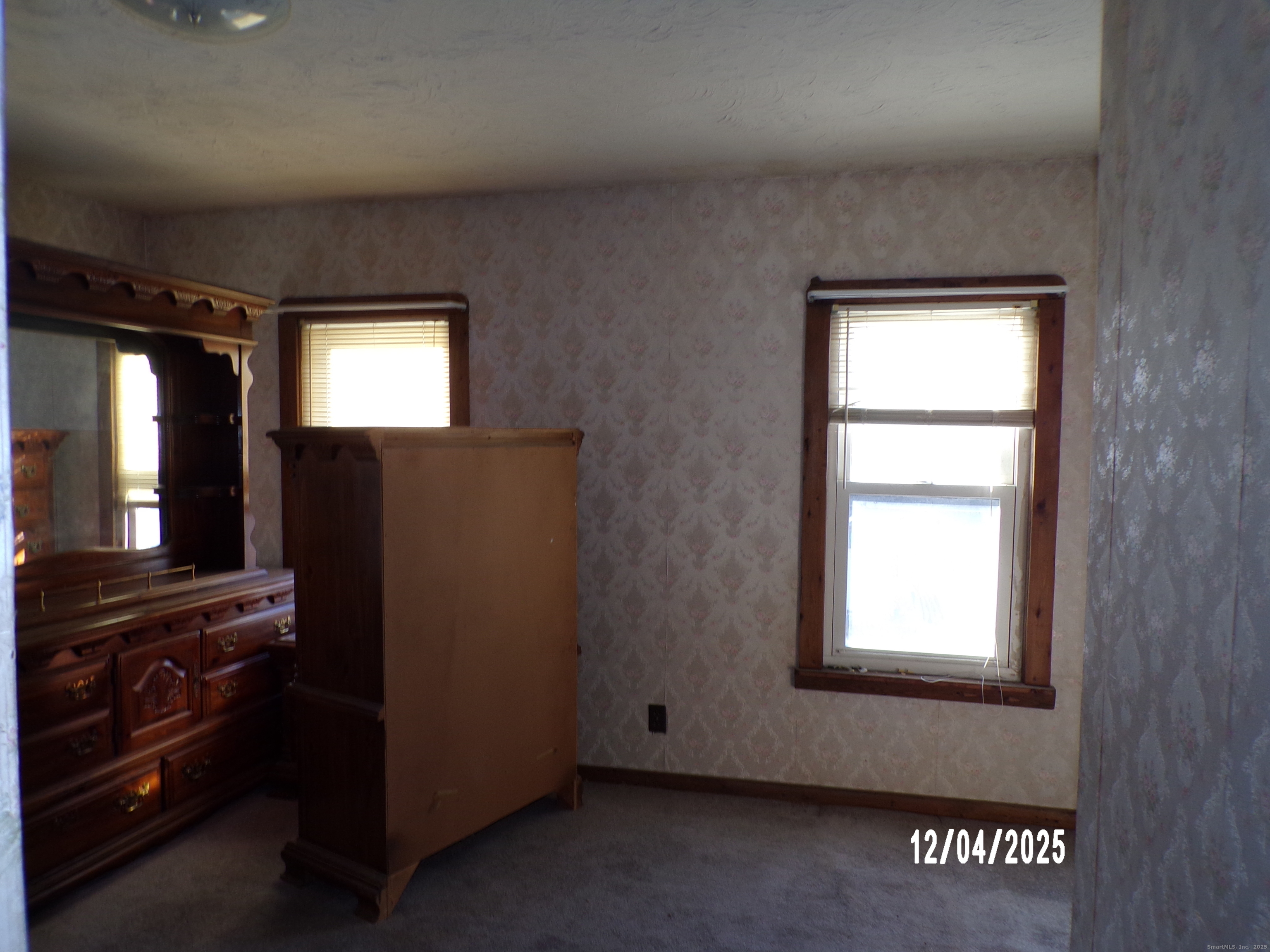103 Myrtle Avenue Ansonia, CT 06401 - Photo 14 of 35 an empty room with wooden floor and windows