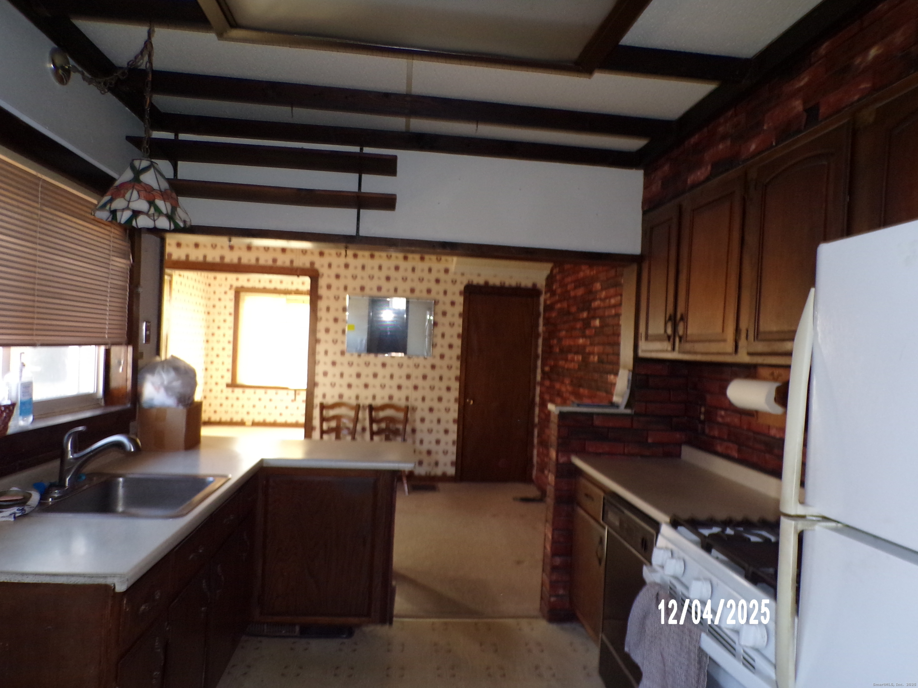 103 Myrtle Avenue Ansonia, CT 06401 - Photo 9 of 35 a kitchen with a refrigerator and a sink