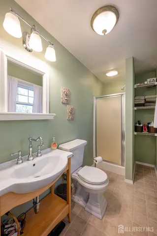 a bathroom with a sink a toilet a mirror and vanity