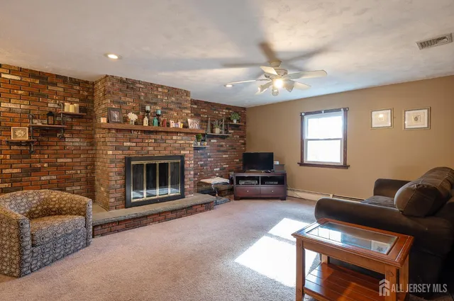a living room with furniture a fireplace and a window